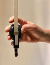 Load image into Gallery viewer, The index finger and pinky are on the bow! Because your index finger and pinky are touching the bow, you use the angle of your hand to control the bow's natural movement.  You can use your arm freely and correctly from the frog to the tip with the WADA BOW GRIP for CELLO.